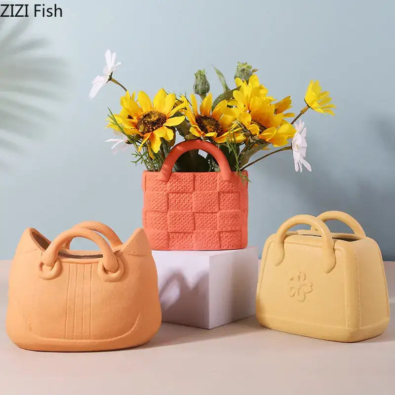 Orange ceramic vase shaped like a handbag with woven texture filled with sunflowers and daisies decorbites handwoven ceramic vase