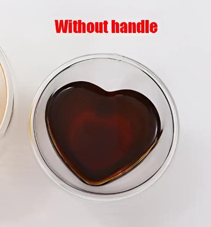 Heart glass mug set featuring a double wall clear glass mug with a dark amber liquid inside decorbites heart glass design