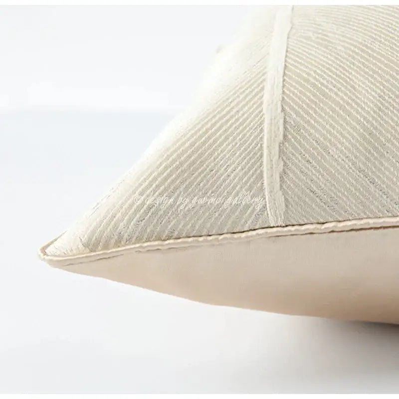 Cream-colored herringbone jacquard cushion with ribbed texture and vertical stitching for beige and white living room decor