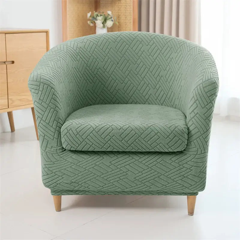 A sage green herringbone jacquard elastic armchair slipcover with textured woven fabric for living room decor