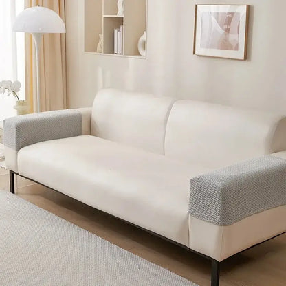 Cream-colored sofa with knit fleece herringbone armrest covers in textured gray fabric and black metal legs