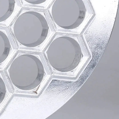 Silver metallic honeycomb-shaped silicone mold with hexagonal indentations for dumpling maker aluminum mold