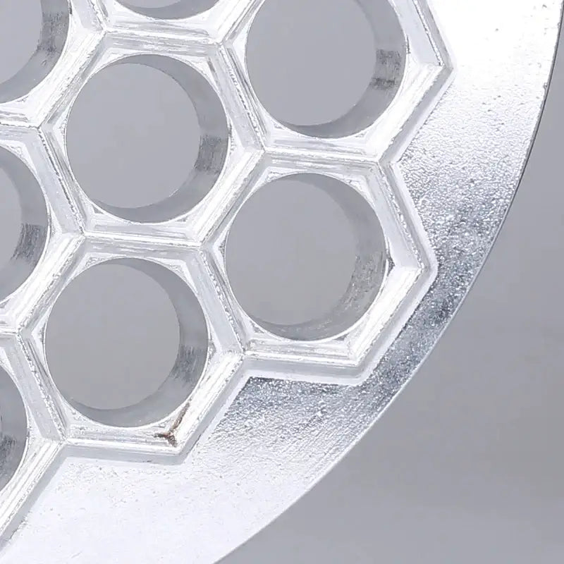 Silver metallic honeycomb-shaped silicone mold with hexagonal indentations for dumpling maker aluminum mold