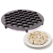Black hexagonal aluminum dumpling maker mold with non stick surface and four small feet for kitchen use
