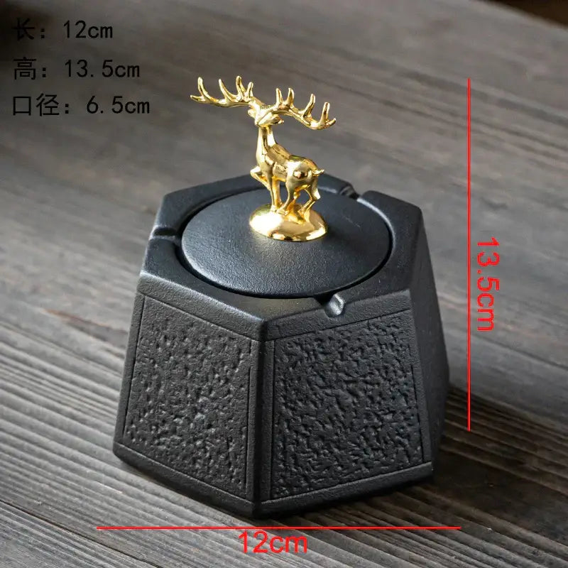Hexagonal black pottery ashtray with textured surface and gold deer figurine lid by decorbites black pottery for living room decor