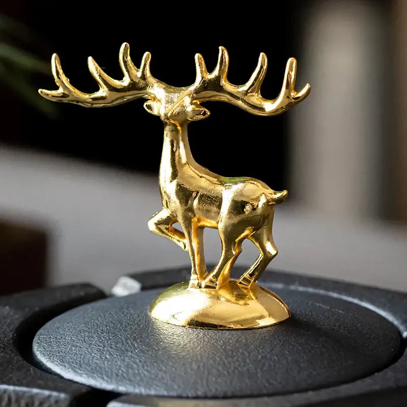 Hexagonal black pottery ashtray with gold deer lid featuring a polished metallic finish for decorbites black pottery decor