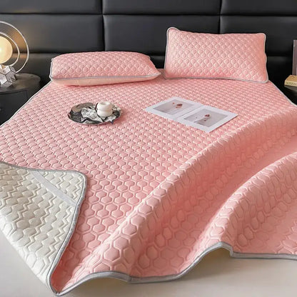 Pink quilted bed sheet set with honeycomb pattern and silver trim for cooling bedroom comfort