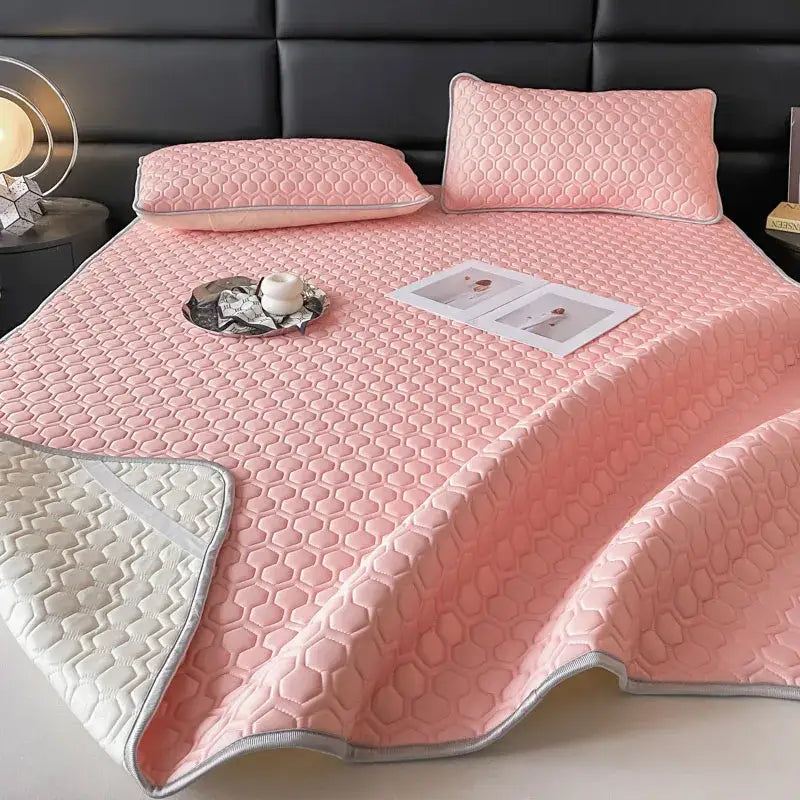 Pink quilted bed sheet set with honeycomb pattern and silver trim for cooling bedroom comfort
