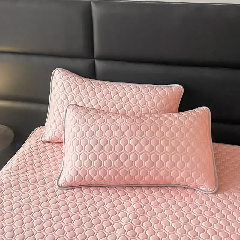 Pink hexagonal quilted pillow sham set with gray piping as part of cooling bed sheet set for bedroom use