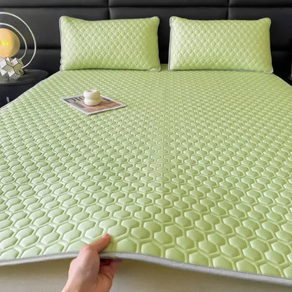 Light green honeycomb-patterned cooling bed sheet with gray border from hexagonal quilted pink and gray sheet set