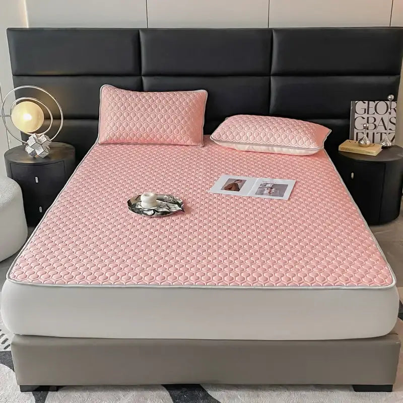 Pink quilted bed sheet set with hexagonal pattern and white piping designed for cooling bedroom comfort