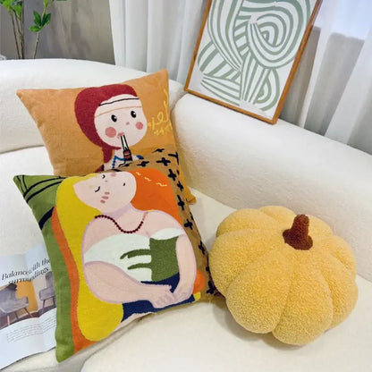 Yellow plush pumpkin-shaped throw pillow with brown stem featuring cartoon oil painting embroidery decorbites cartoon oil decor