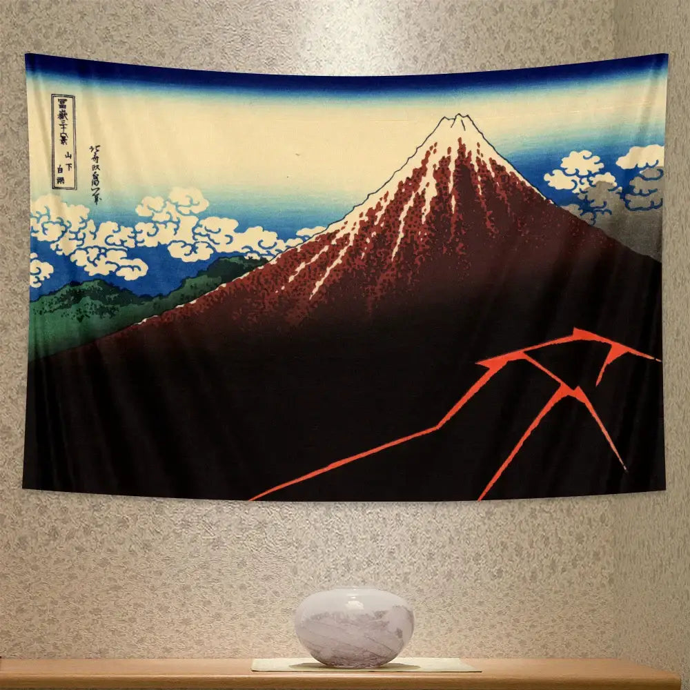 Black fabric beach scenery tapestry featuring stylized mount fuji with red white peaks blue sky and green foothills in ukiyo-e style