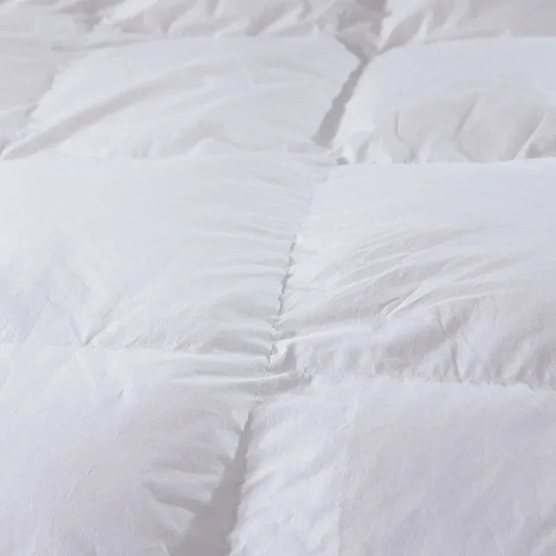 White quilted comforter with soft plush texture and evenly stitched panels 100 percent cotton cover king size