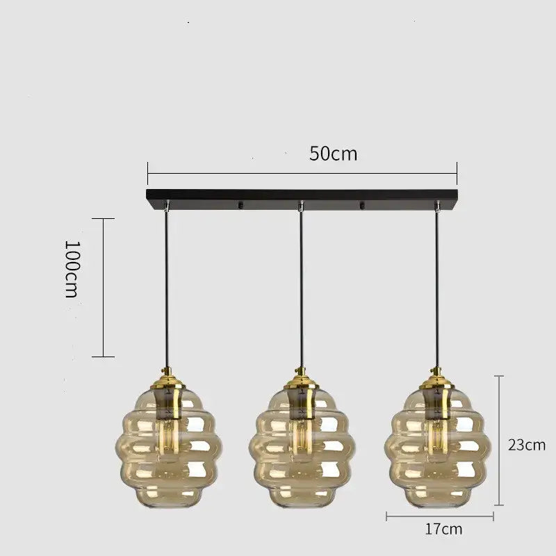 Modern honeycomb pendant light with amber glass shades and brass accents perfect for kitchen dining decorbites colorful glass