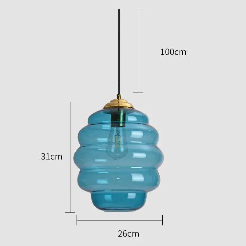 Blue honeycomb-shaped glass pendant light with brass fixture and exposed bulb for kitchen dining decorbites colorful glass