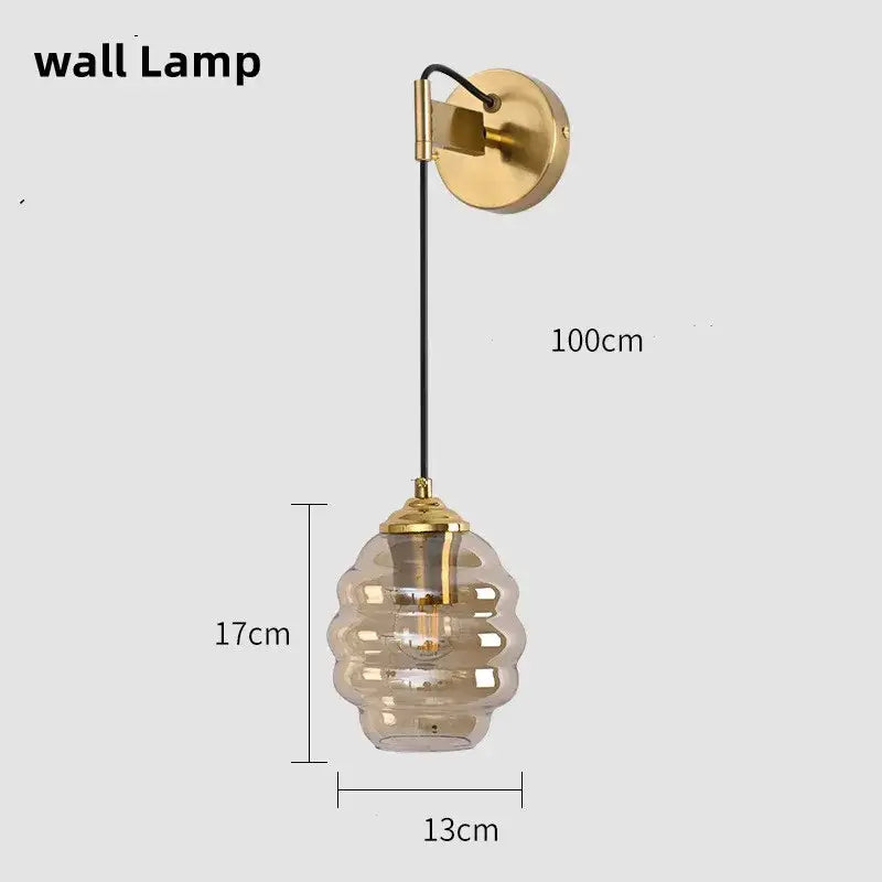 Gold-toned pendant light with honeycomb amber glass shade suspended by black cord for kitchen dining decorbites colorful glass
