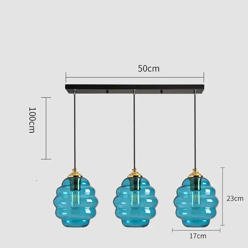 Set of three teal honeycomb-shaped glass pendant lights with brass accents for kitchen dining decorbites colorful glass