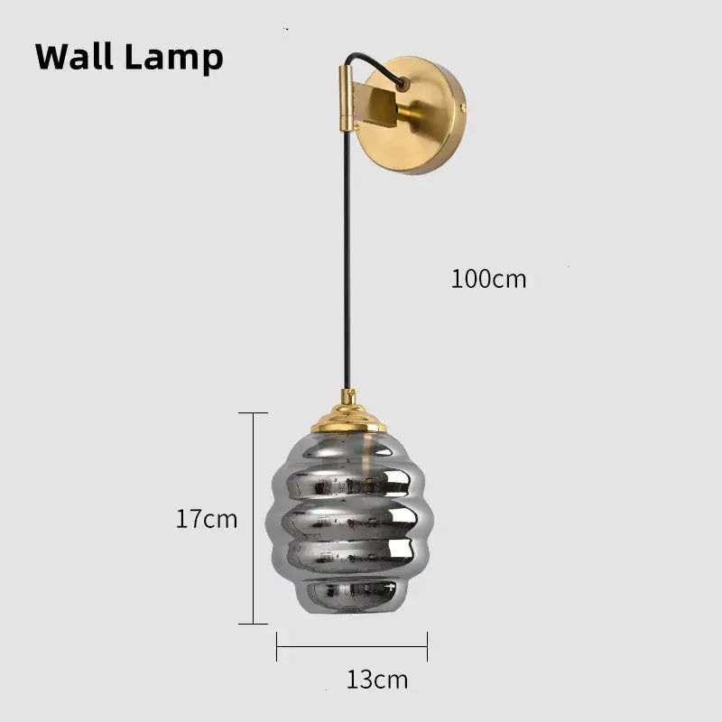A modern pendant light with gold metal bracket and tiered silver glass shade for kitchen dining decorbites colorful glass