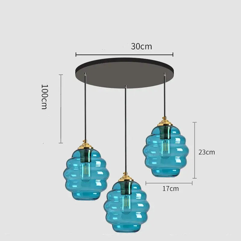 Blue honeycomb-shaped glass pendant light with gold-toned fixtures for kitchen dining decorbites colorful glass