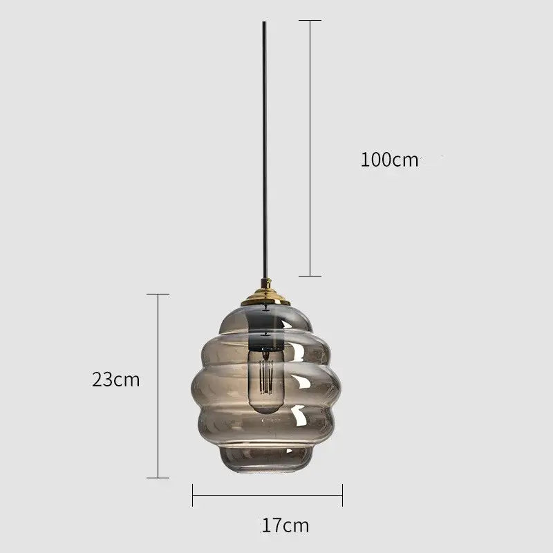 A modern pendant light with tiered honeycomb smoked gray glass and brass accents for kitchen dining decorbites colorful glass