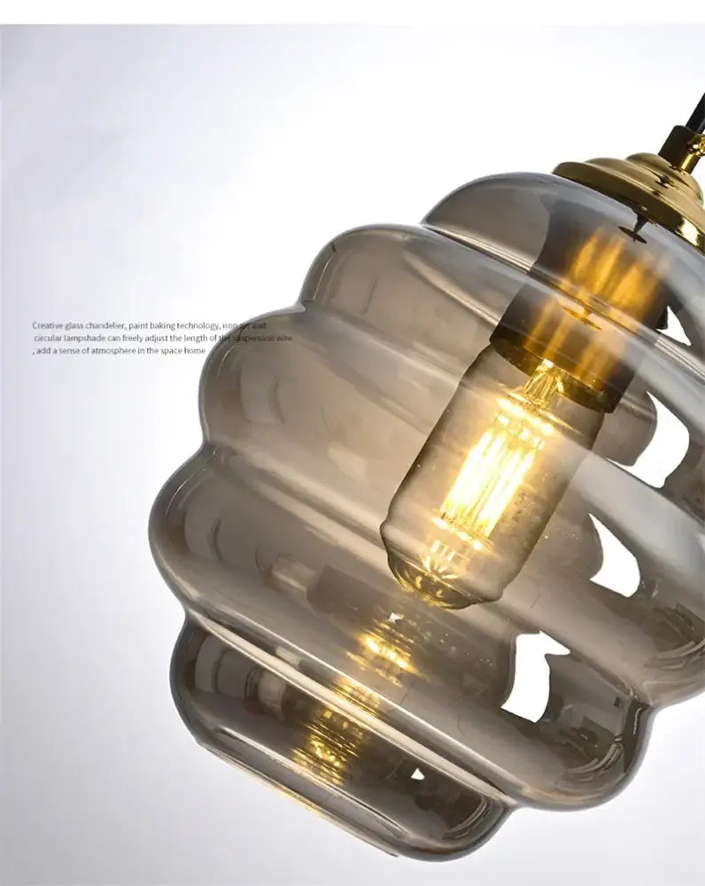 A modern honeycomb amber blue and gray glass pendant light with a warm glow for kitchen dining decorbites colorful glass