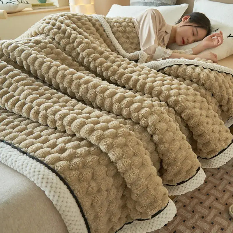 Beige plush coral fleece bed blanket with textured pom-pom pattern and white knitted trim from decorbites cozy coral collection