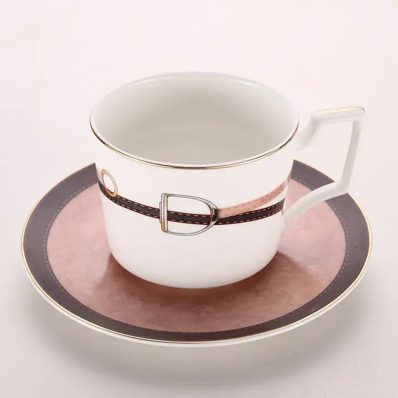 White porcelain espresso cup with brown leather strap and silver buckle on matching saucer from decorbites bone china tableware set