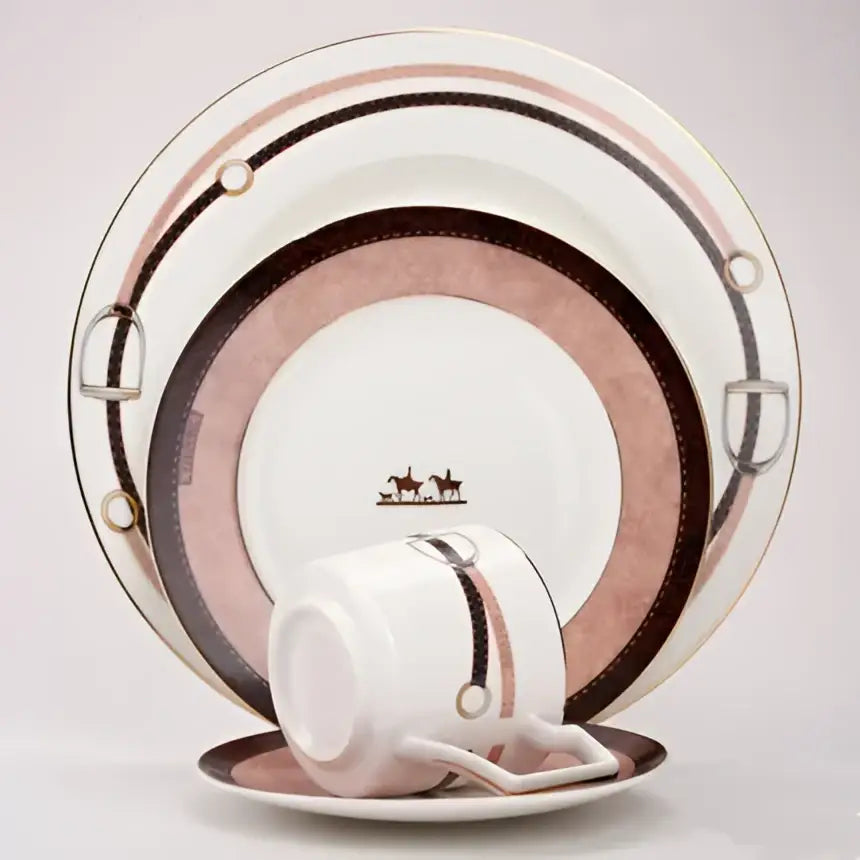 A white porcelain coffee cup and saucer with pink and brown stripes and horsebit accents from decorbites bone china tableware set