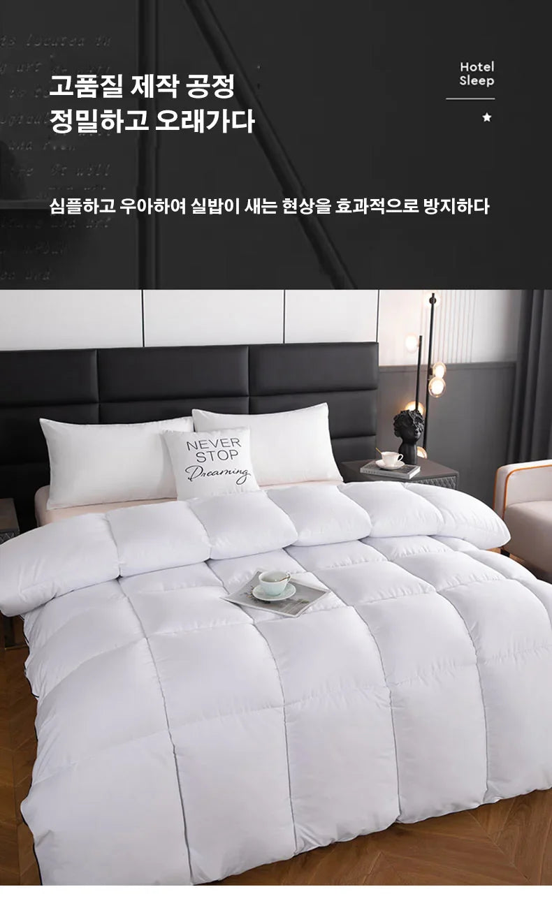 White quilted comforter with plush puffy texture and square stitched panels for a lightweight breathable winter quilt