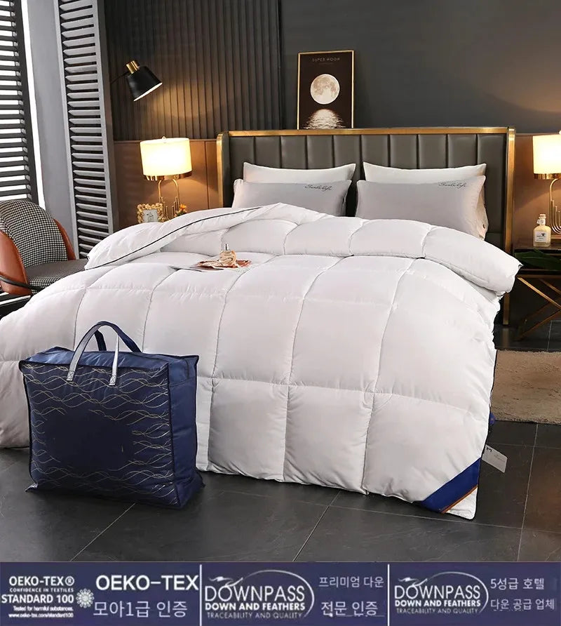 White quilted down and feather hotel style comforter with blue accent stripe in a modern bedroom setting