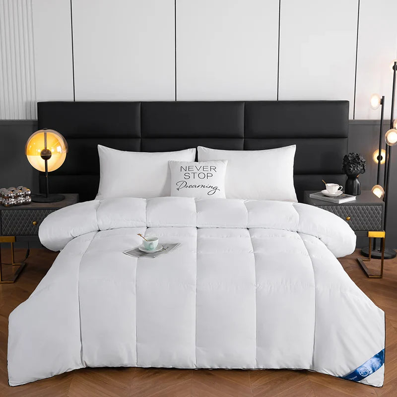White quilted lightweight hotel style comforter with soft plush texture and vertical stitching for cozy winter use