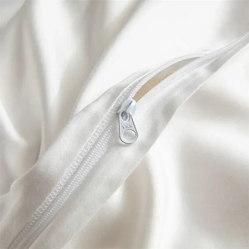 A sleek white zipper with metallic pull tab on smooth satin fabric in hotel style white & black 1000tc egyptian cotton bedding set by decorbites