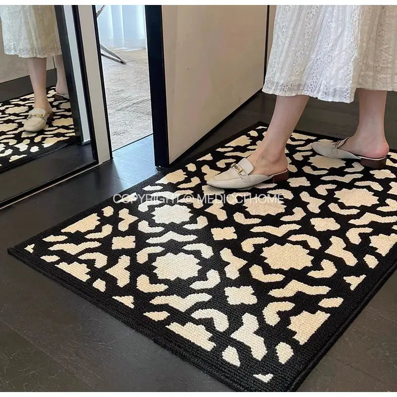 Houndstooth black ivory woven area rug with black and cream geometric pattern and thick textured surface for living room decor