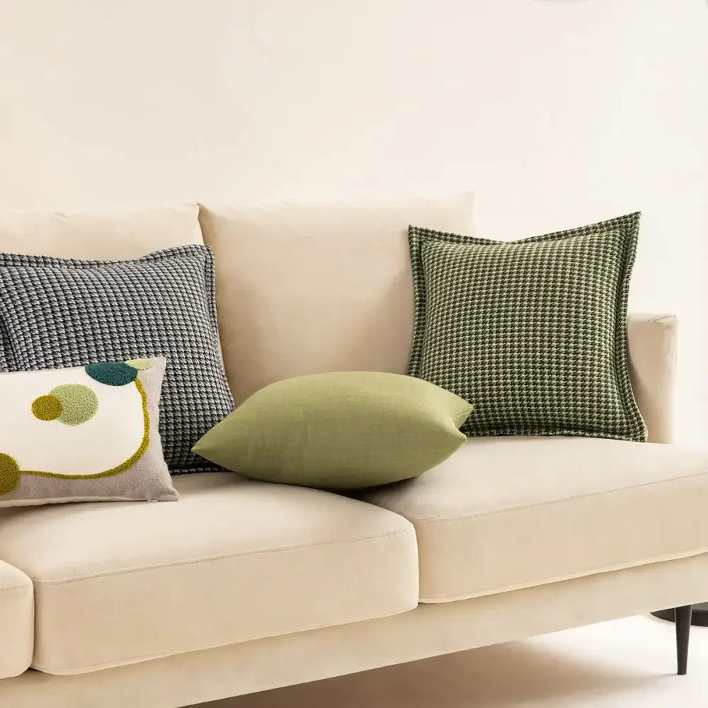 Beige velvet sofa with decorbites hounds tooth square cushion cover and decorative green and gray pillows for living room decor
