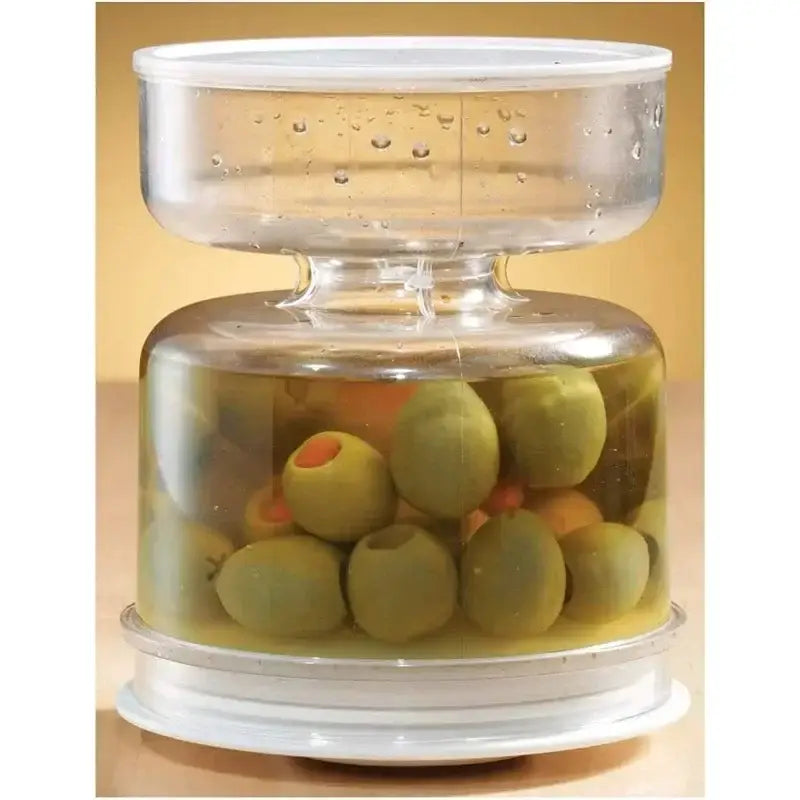 Clear plastic olive dispenser jar with white lid and base designed for green olives in brine by Decorbites Hourglass Pickle