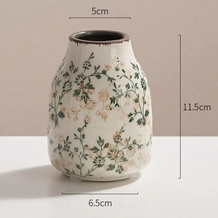 A white crackle vase ceramic with delicate green beige floral patterns and a flared rim for home decoration