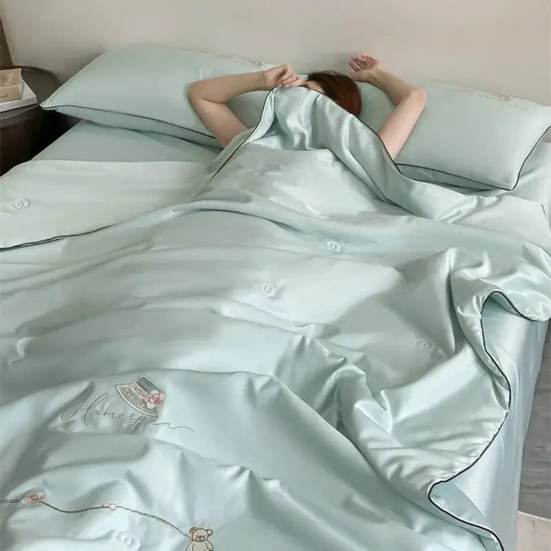 Light blue satin duvet set with subtle embroidery and black piping from decorbites ice rayon summer quilt collection