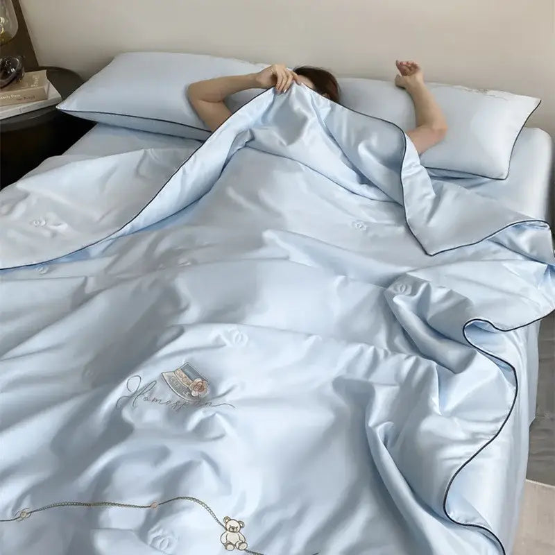 Light blue satin duvet cover set with cream bear embroidery and home script from decorbites ice rayon summer quilt collection