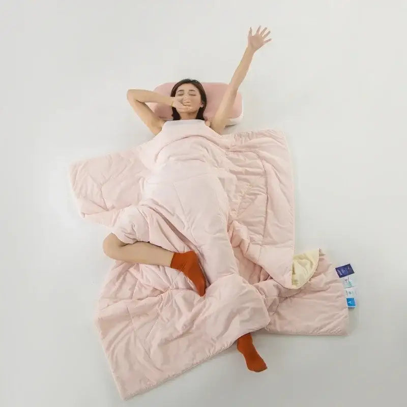 Soft pink quilted decorbites ice silk cooling blanket with plush texture and subtle stitching for bedroom comfort