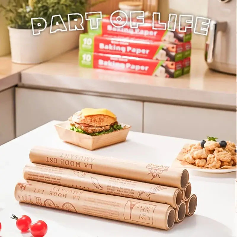 Stack of beige grease-resistant baking paper rolls with embossed illustrations for kitchen food wrapping use