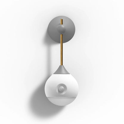 Modern white and gray wall sconce with brass accents.