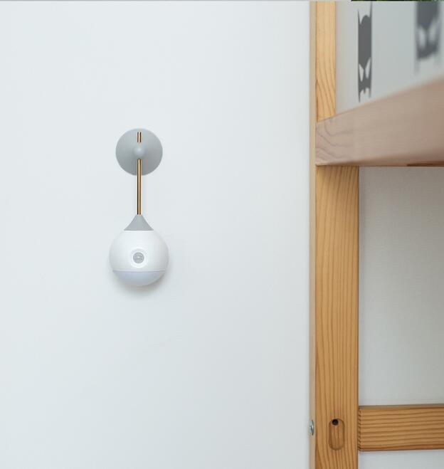 White and gray wall-mounted light fixture with a spherical design.