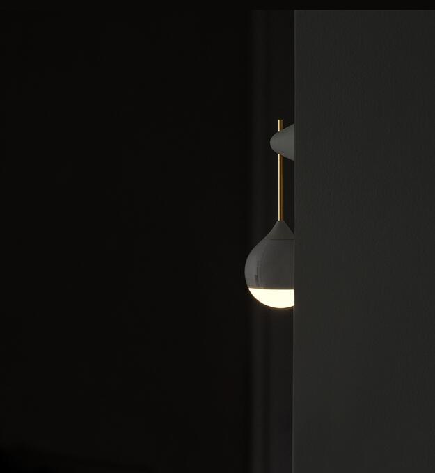 White ceramic teardrop-shaped light bulb with gold accents and a minimalist design.