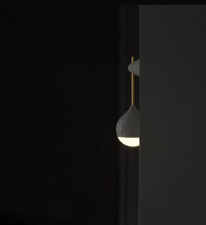 White ceramic teardrop-shaped light bulb with gold accents and a minimalist design.