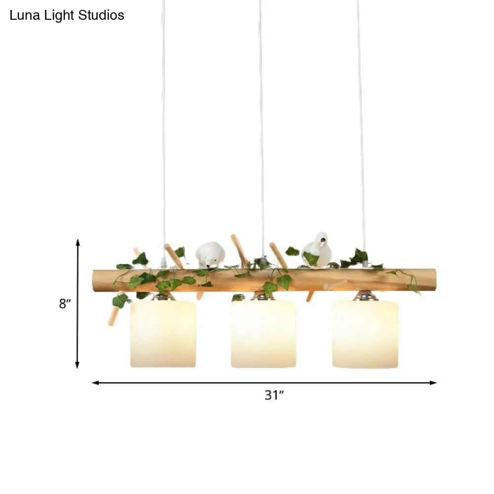 DecorBites™ Industrial 3-Light Hanging Pendant for Coffee Shop with Milky Glass Cylinder, Wooden Stick, and Bird Accent