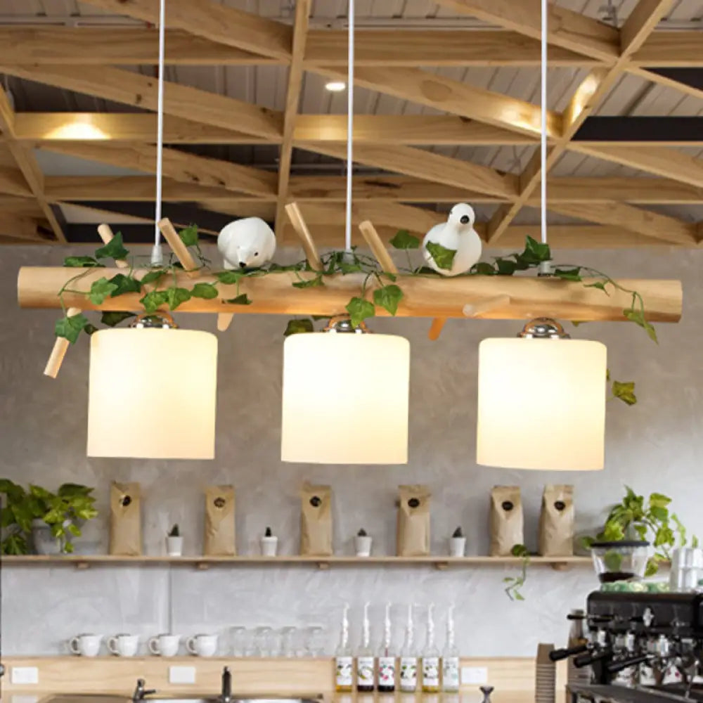 DecorBites™ Industrial 3-Light Hanging Pendant for Coffee Shop with Milky Glass Cylinder, Wooden Stick, and Bird Accent