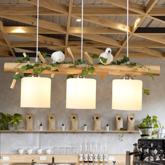 DecorBites™ Industrial 3-Light Hanging Pendant for Coffee Shop with Milky Glass Cylinder, Wooden Stick, and Bird Accent