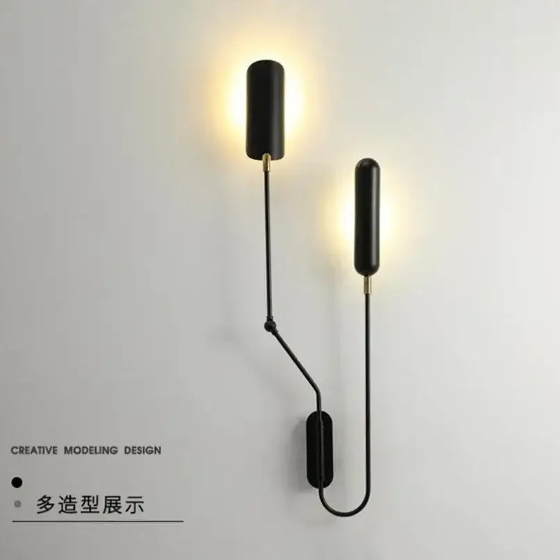 Black cylindrical wall lamp with slender metal arms and gold-toned accents decorbites industrial adjustable led design