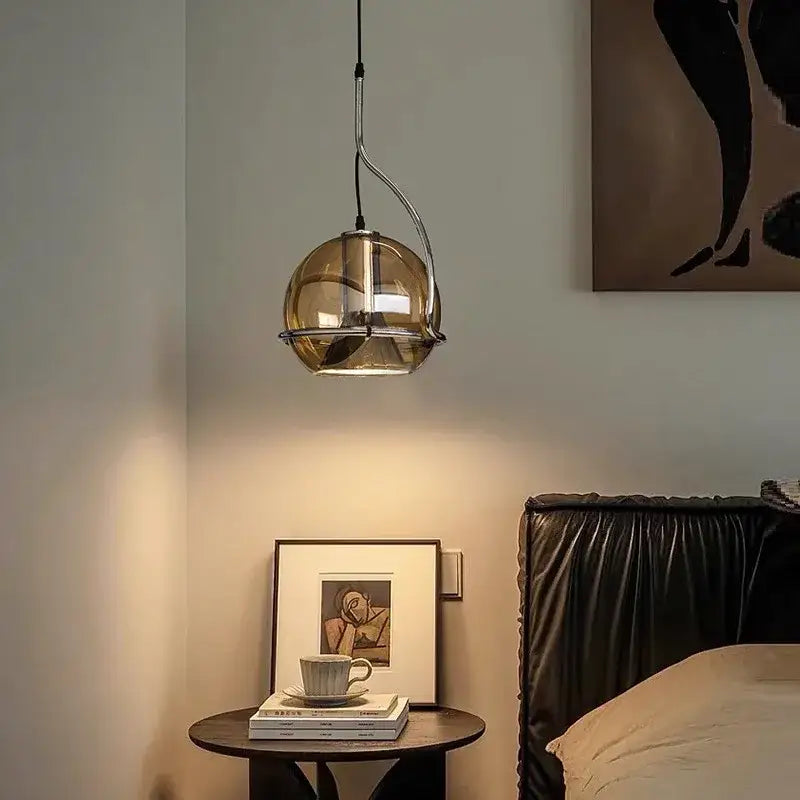 A sleek industrial amber glass pendant light with amber-tinted glass and chrome frame for kitchen decorbites industrial amber style